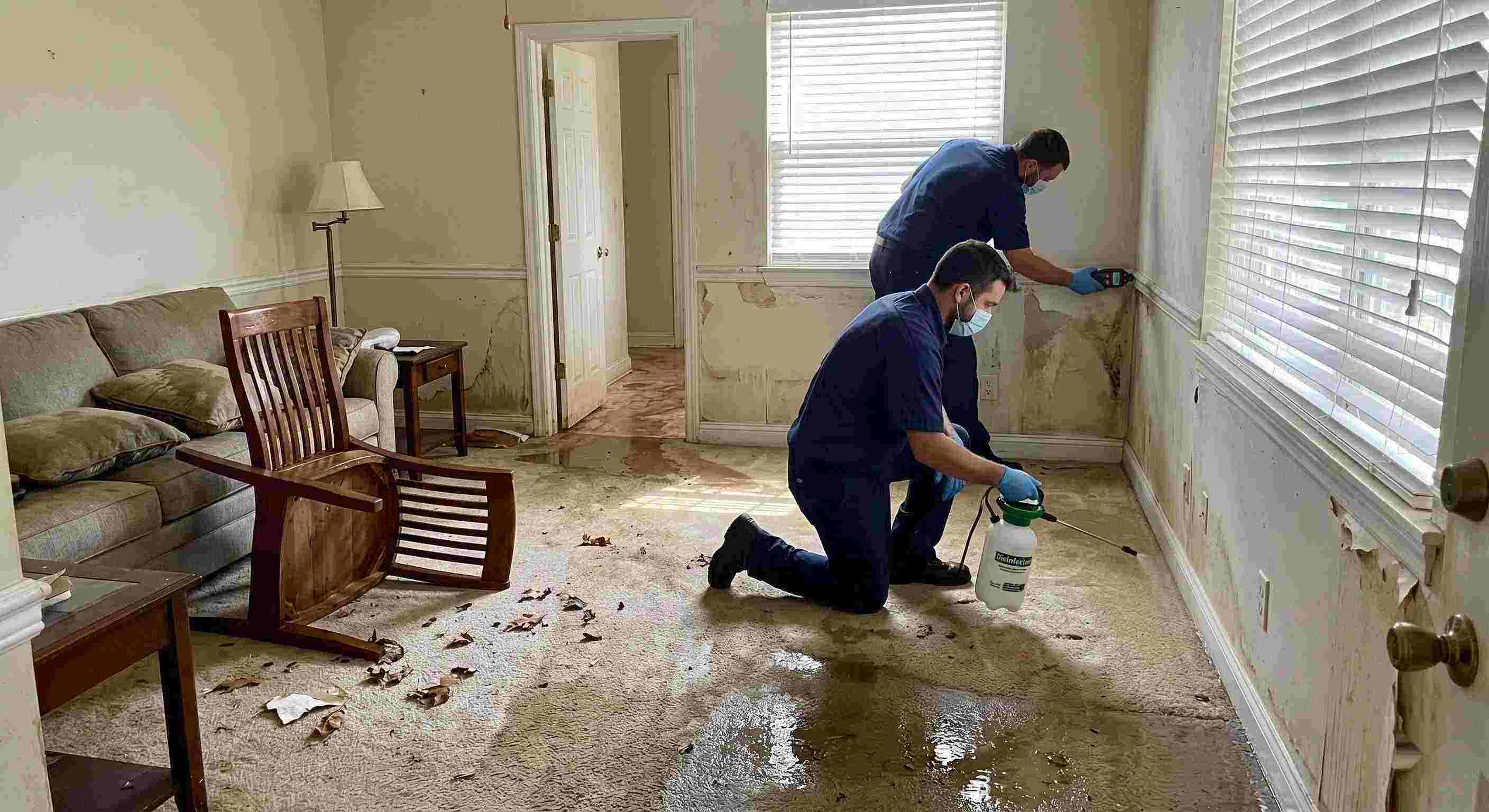 Technicians performing flood disinfection after water damage inside a home in Chesapeake, ensuring wet floors, damp walls, and household items are sanitized safely.